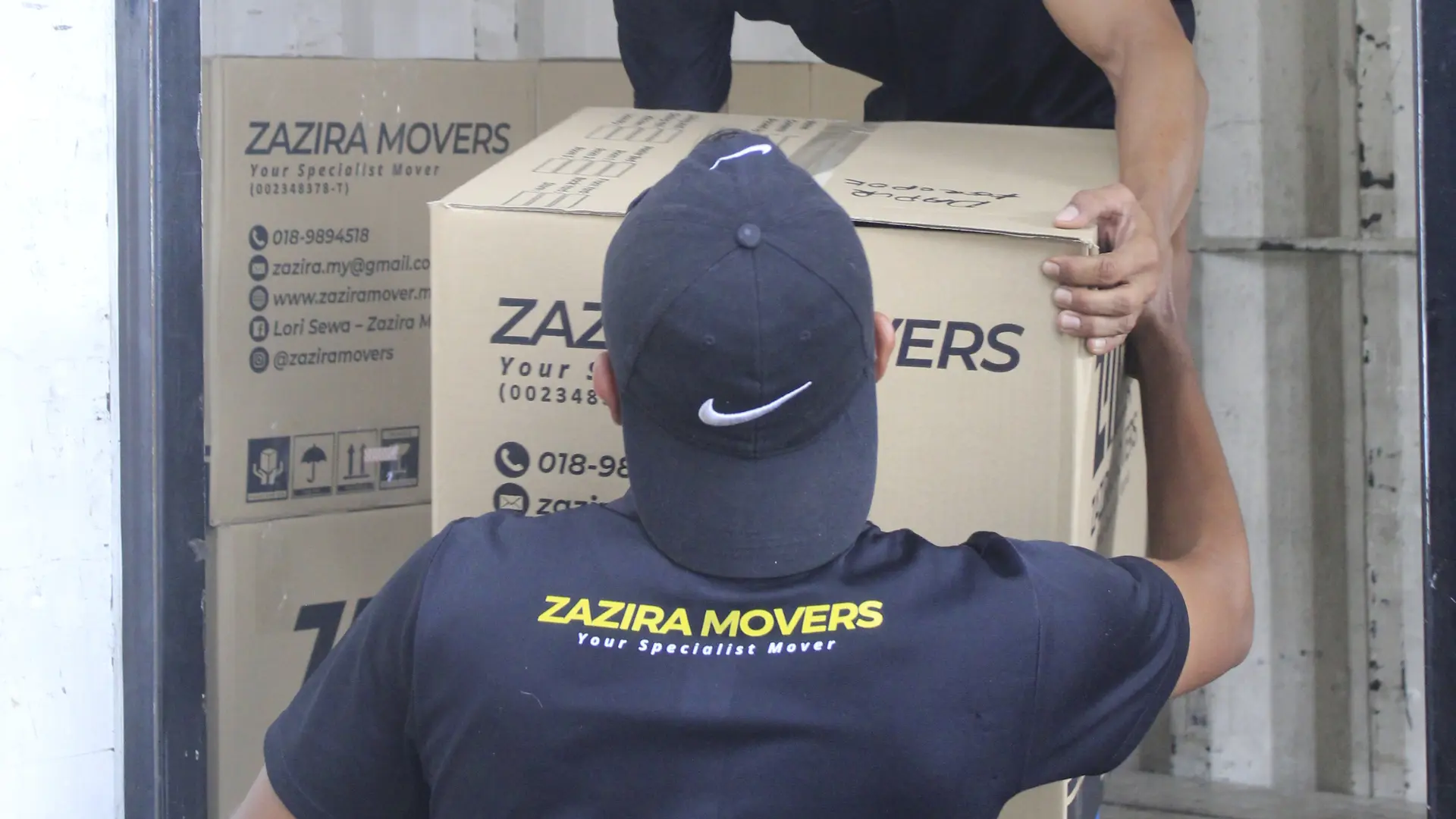 Movers in Ipoh 3 Moving crew loading packed household items into a Zazira Movers lorry