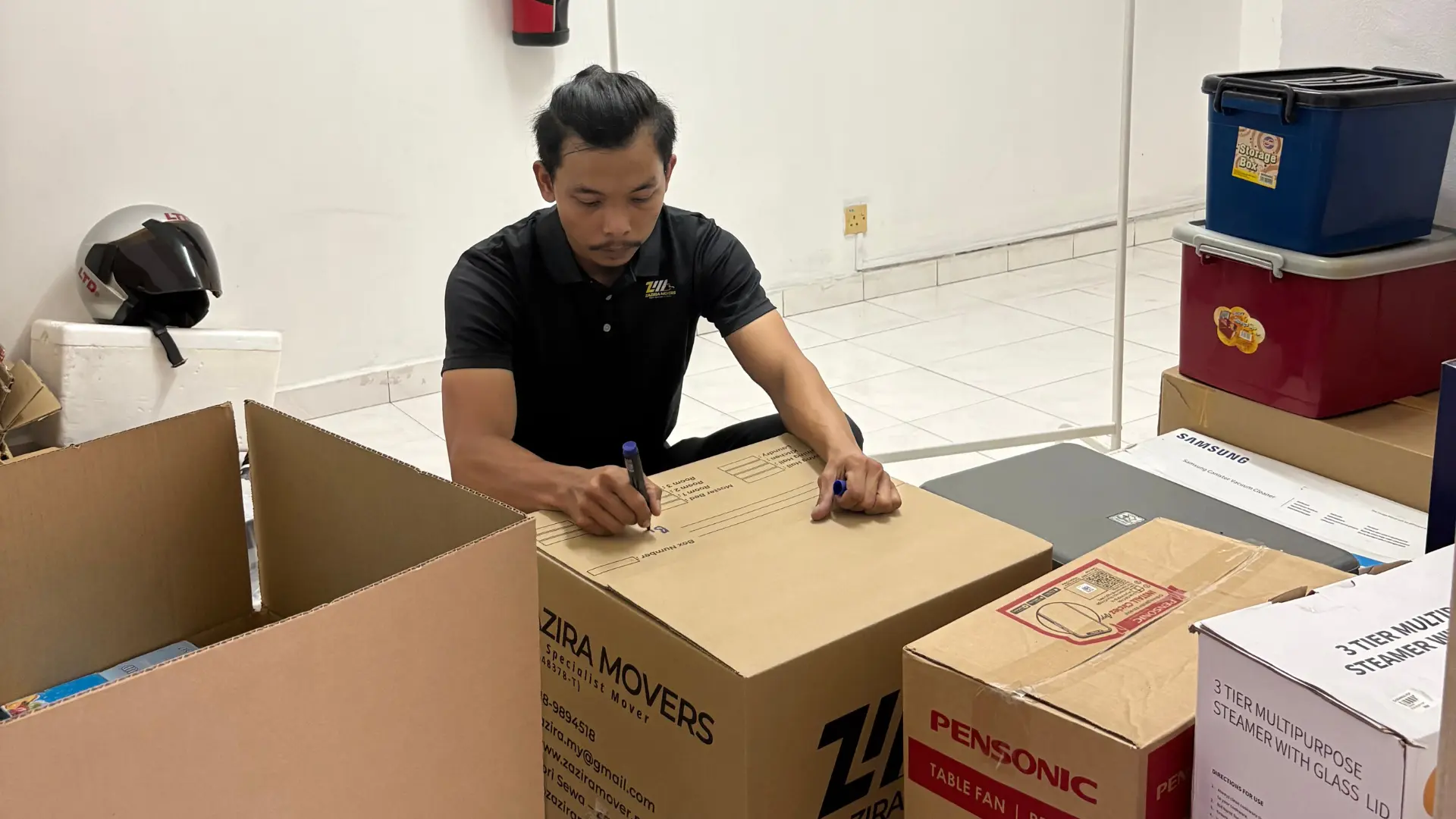 Cleaning Services 4 Zazira Movers packing household items into labelled moving boxes