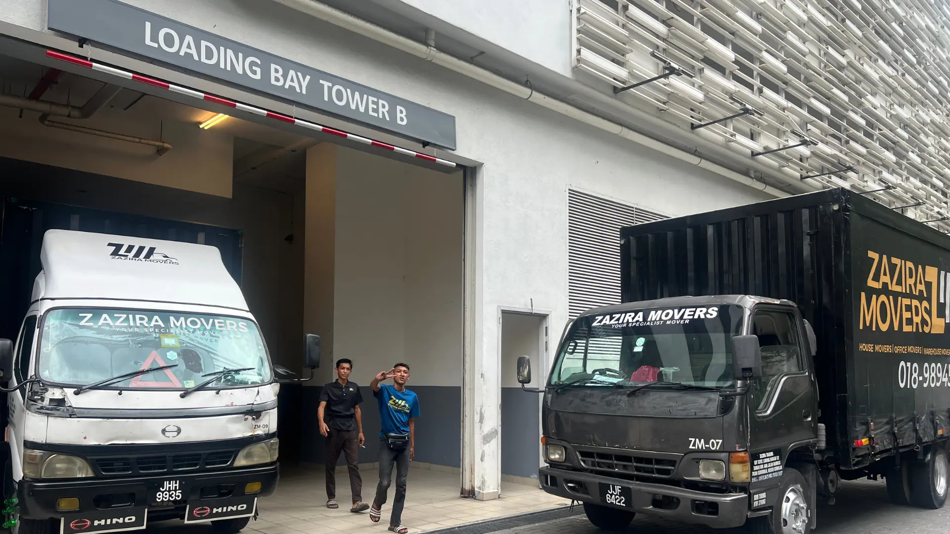 moving team reviewing warehouse loading access for a 10-tonne lorry move in Malaysia